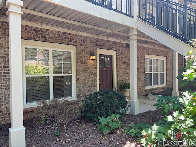 doorway to property with brick siding