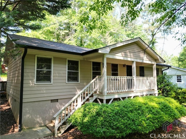 ranch-style house with a porch, crawl space, and stairs