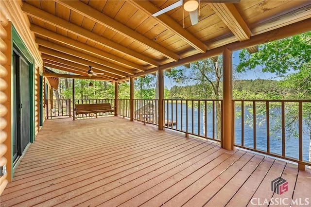 wooden terrace with a water view and a ceiling fan