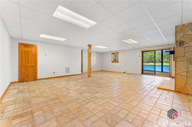 interior space with baseboards, visible vents, and a drop ceiling