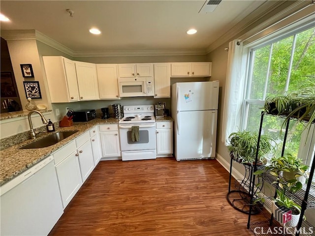 kitchen featuring visible vents, ornamental molding, white appliances, white cabinets, and a sink