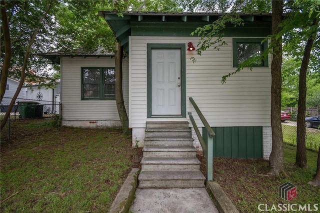 entrance to property featuring fence and central AC unit