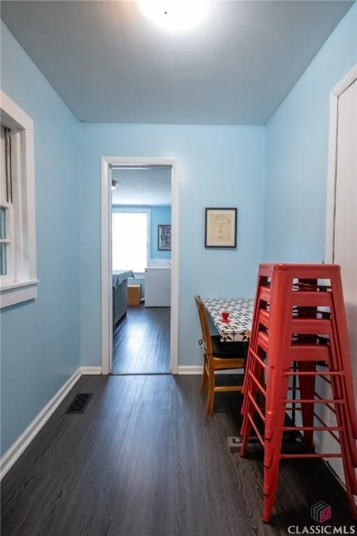 dining area featuring visible vents, baseboards, and wood finished floors