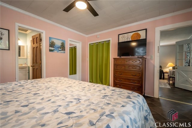 bedroom with crown molding, dark tile patterned floors, ceiling fan, and ensuite bathroom