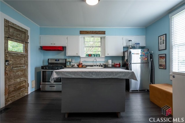 kitchen featuring plenty of natural light, a sink, appliances with stainless steel finishes, and white cabinets