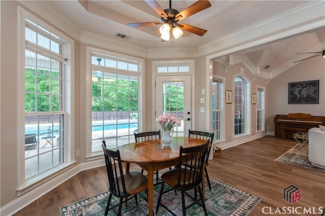 dining space featuring visible vents, dark wood-type flooring, ceiling fan, and crown molding