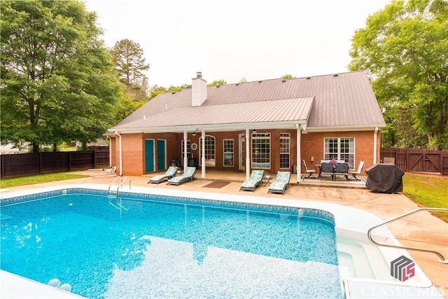 view of swimming pool featuring a patio, a fenced backyard, and a fenced in pool