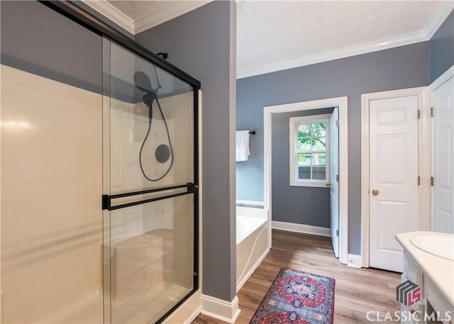 full bathroom with crown molding, a bath, wood finished floors, and a shower stall