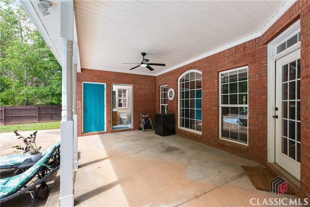 view of patio / terrace with fence and a ceiling fan