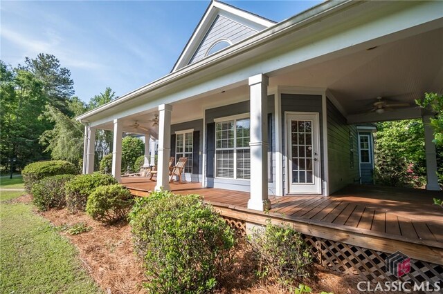 view of side of property with covered porch and ceiling fan