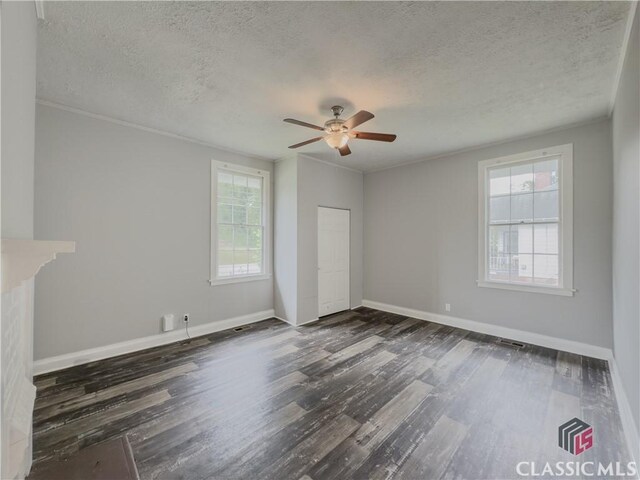 1114 S Broad St, Monroe, GA 30655 - unfurnished bedroom featuring baseboards, a textured ceiling, and dark wood finished floors