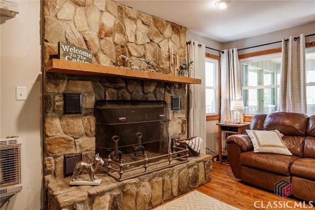 50 Atlanta Ln, Clayton, GA 30525 - living room with visible vents, heating unit, wood finished floors, and a stone fireplace