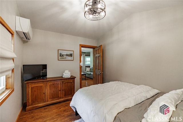50 Atlanta Ln, Clayton, GA 30525 - bedroom featuring wood finished floors, a wall mounted AC, and vaulted ceiling