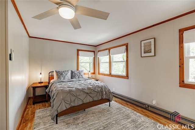50 Atlanta Ln, Clayton, GA 30525 - bedroom with crown molding, a baseboard radiator, wood finished floors, and multiple windows