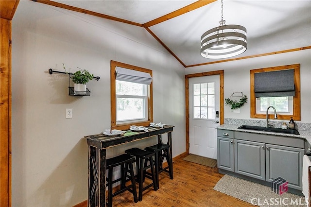 50 Atlanta Ln, Clayton, GA 30525 - interior space featuring gray cabinets, wood finished floors, a sink, baseboards, and lofted ceiling