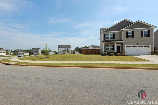 craftsman inspired home with a garage, fence, concrete driveway, and a front yard