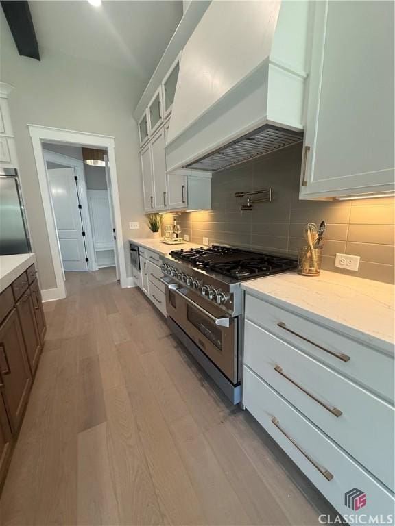 1200 Askew Trl, Greensboro, GA 30642 - kitchen featuring premium range hood, high end range, decorative backsplash, and light wood finished floors