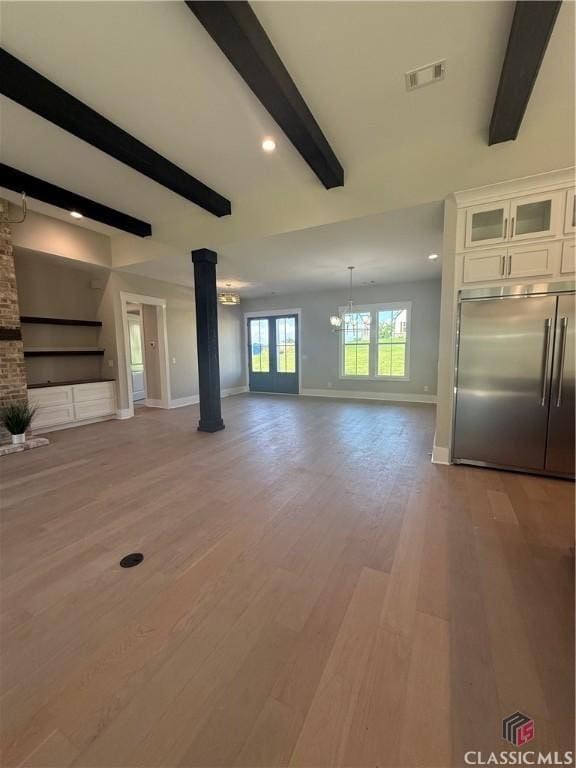 1200 Askew Trl, Greensboro, GA 30642 - unfurnished living room featuring ornate columns, beam ceiling, a chandelier, light wood-style flooring, and recessed lighting