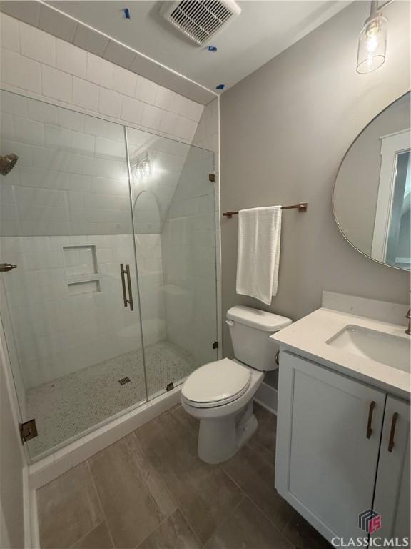 1200 Askew Trl, Greensboro, GA 30642 - full bath with vanity, a stall shower, and wood finished floors