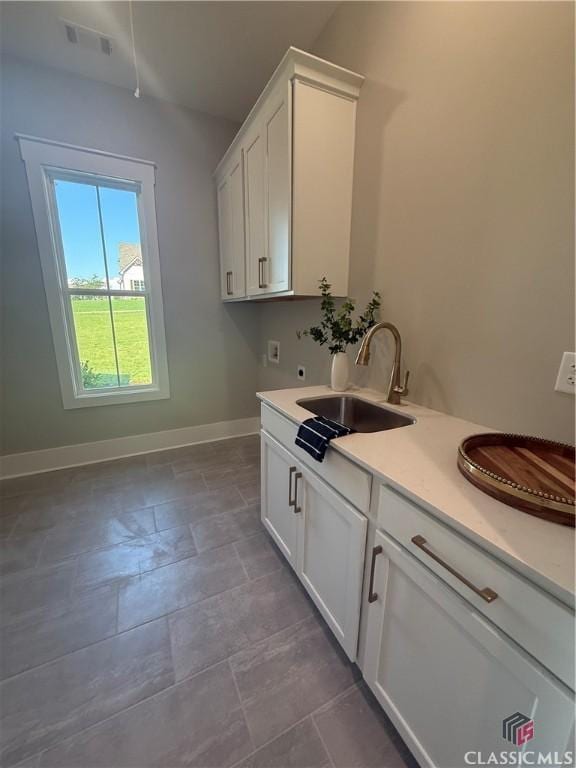 1200 Askew Trl, Greensboro, GA 30642 - laundry area featuring washer hookup, cabinet space, hookup for an electric dryer, and stone finish flooring