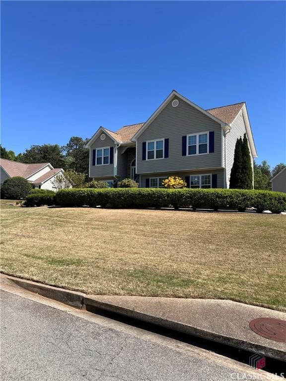 raised ranch featuring a front yard