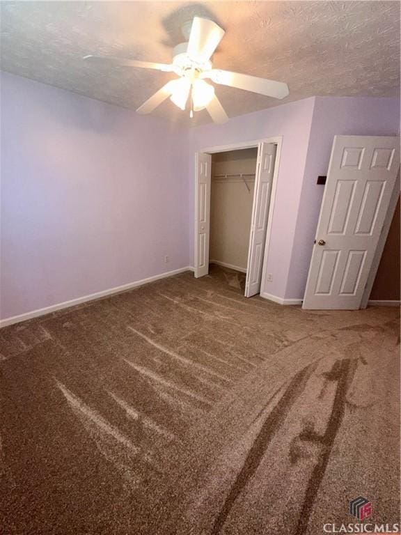 unfurnished bedroom featuring baseboards, carpet, a ceiling fan, and a textured ceiling
