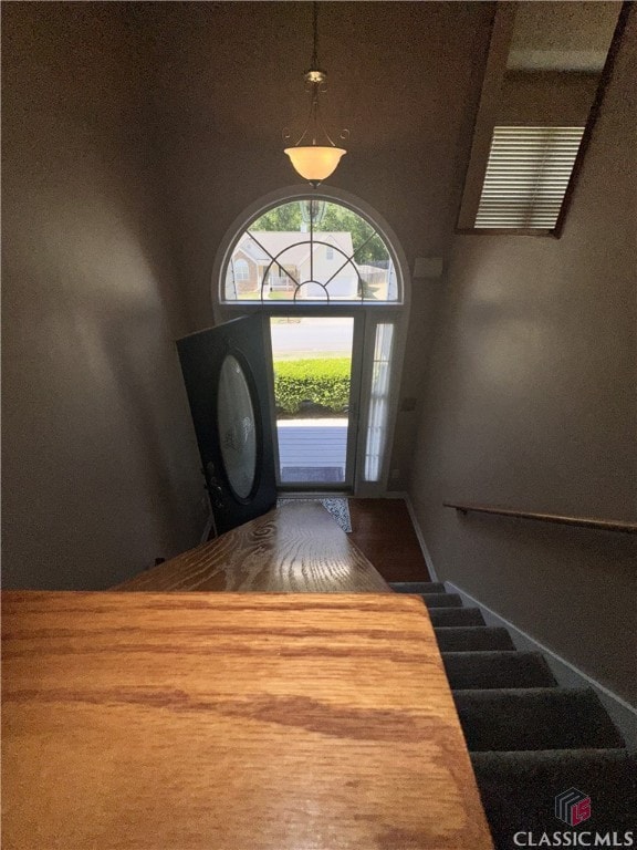 entryway featuring a towering ceiling