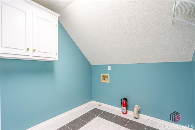 1130 Latham Dr, Watkinsville, GA 30677 - washroom with cabinet space, washer hookup, baseboards, dark tile patterned floors, and a textured ceiling