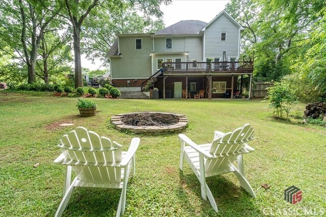 1130 Latham Dr, Watkinsville, GA 30677 - back of house featuring stairway, a deck, an outdoor fire pit, and a lawn