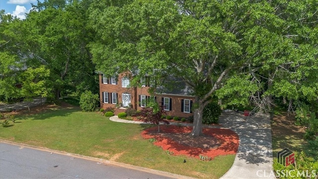 1130 Latham Dr, Watkinsville, GA 30677 - colonial-style house featuring a front lawn and brick siding