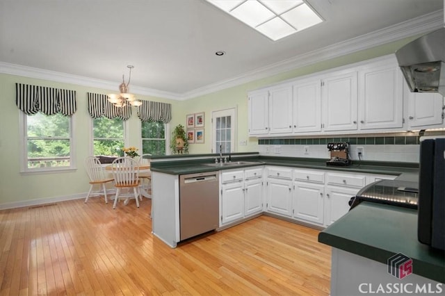 1130 Latham Dr, Watkinsville, GA 30677 - kitchen with dishwasher, a peninsula, dark countertops, wall chimney range hood, and crown molding