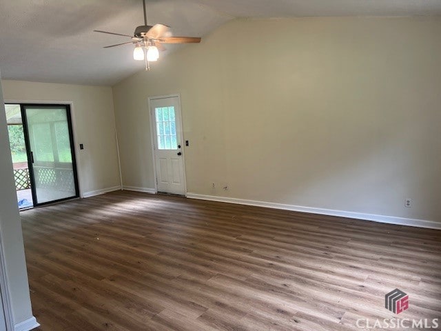 unfurnished living room with baseboards, ceiling fan, wood finished floors, and lofted ceiling