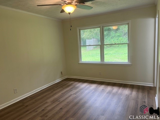 spare room with a ceiling fan, a textured ceiling, a healthy amount of sunlight, and dark wood-style floors