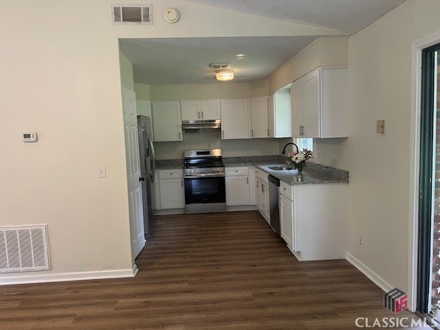 kitchen featuring under cabinet range hood, stainless steel appliances, white cabinetry, and visible vents