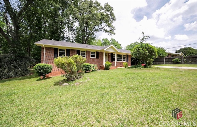 120 Hunt Rd, Athens, GA 30606 - ranch-style house with brick siding, fence, and a front lawn