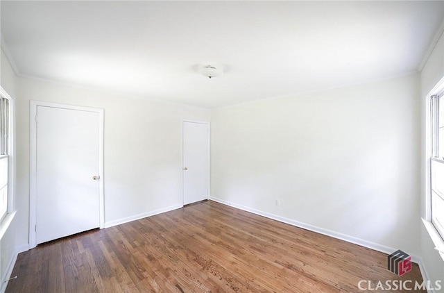 120 Hunt Rd, Athens, GA 30606 - unfurnished bedroom with baseboards, multiple windows, wood finished floors, and ornamental molding