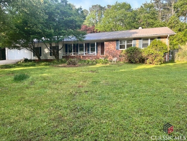 735 Timothy Rd, Athens, GA 30606 - ranch-style home with an attached garage, brick siding, metal roof, and a front yard