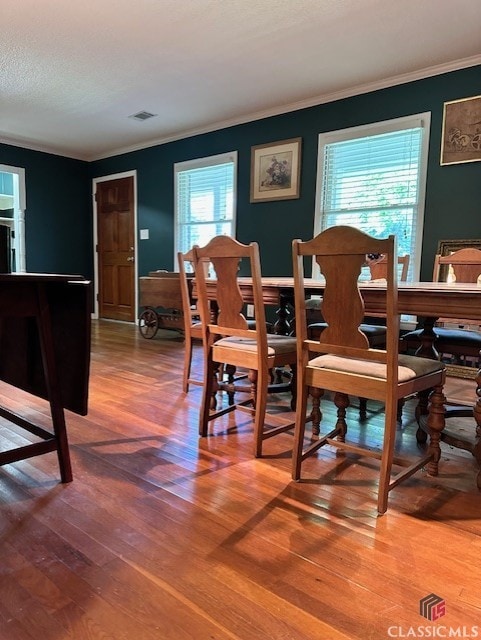 735 Timothy Rd, Athens, GA 30606 - dining room with crown molding, visible vents, and wood finished floors