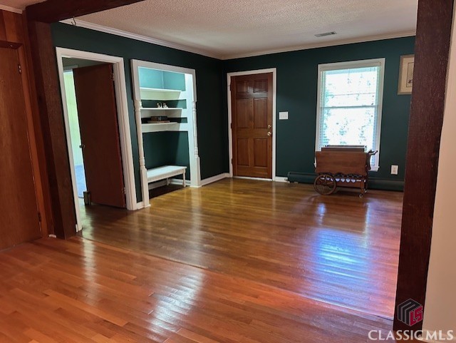 735 Timothy Rd, Athens, GA 30606 - foyer entrance with ornamental molding, a textured ceiling, and wood finished floors