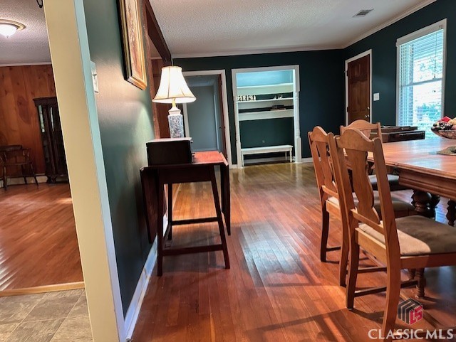 735 Timothy Rd, Athens, GA 30606 - dining area featuring crown molding, a textured ceiling, visible vents, and wood finished floors