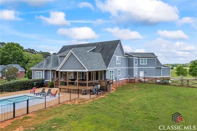 back of house with a patio area, a yard, a fenced backyard, a fenced in pool, and a shingled roof
