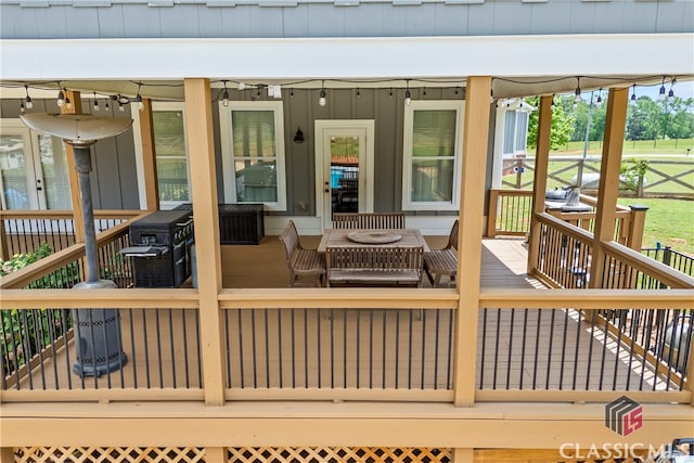 wooden deck featuring a grill
