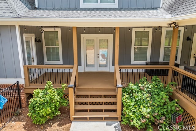 property entrance with a porch, a shingled roof, and board and batten siding