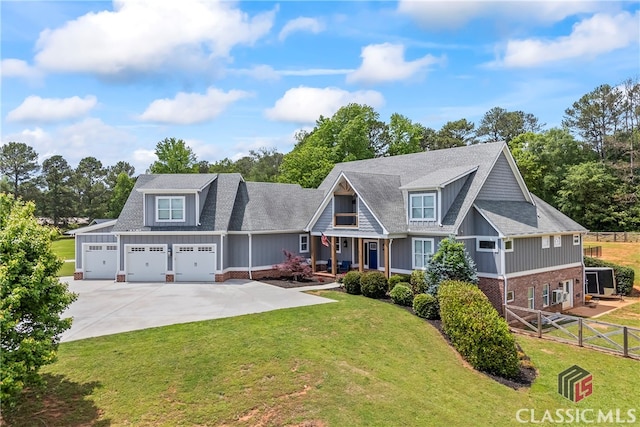 craftsman inspired home with fence, an attached garage, brick siding, driveway, and a front yard