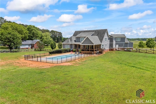 view of pool featuring a patio, fence, a lawn, and a fenced in pool