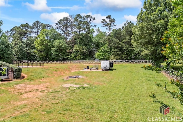 view of yard featuring an outdoor fire pit, a storage shed, an outdoor structure, and a fenced backyard