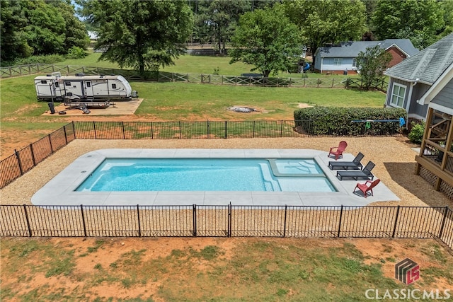 view of swimming pool featuring a patio area, a fenced backyard, a lawn, and a fenced in pool