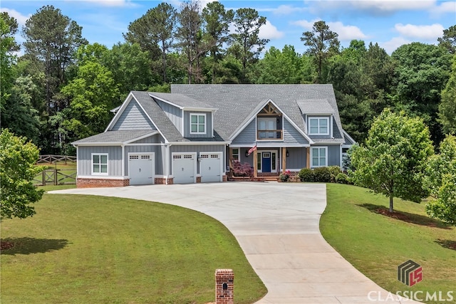 craftsman-style home featuring fence, a shingled roof, board and batten siding, a front yard, and driveway