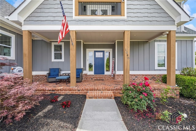 entrance to property featuring board and batten siding and a porch