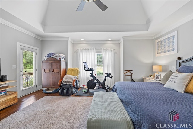 bedroom featuring ornamental molding, wood finished floors, access to exterior, and multiple windows
